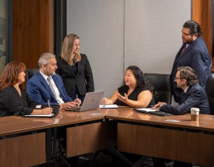 Six members of Bob Katz team seated discussing a case